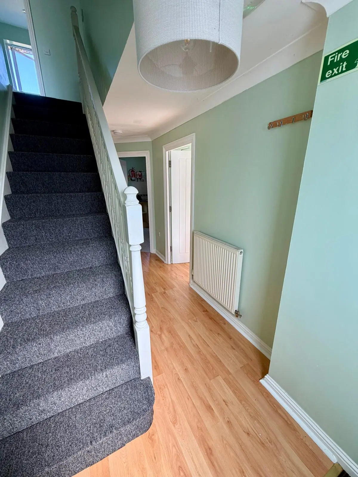 Entrance hallway with staircase and radiator